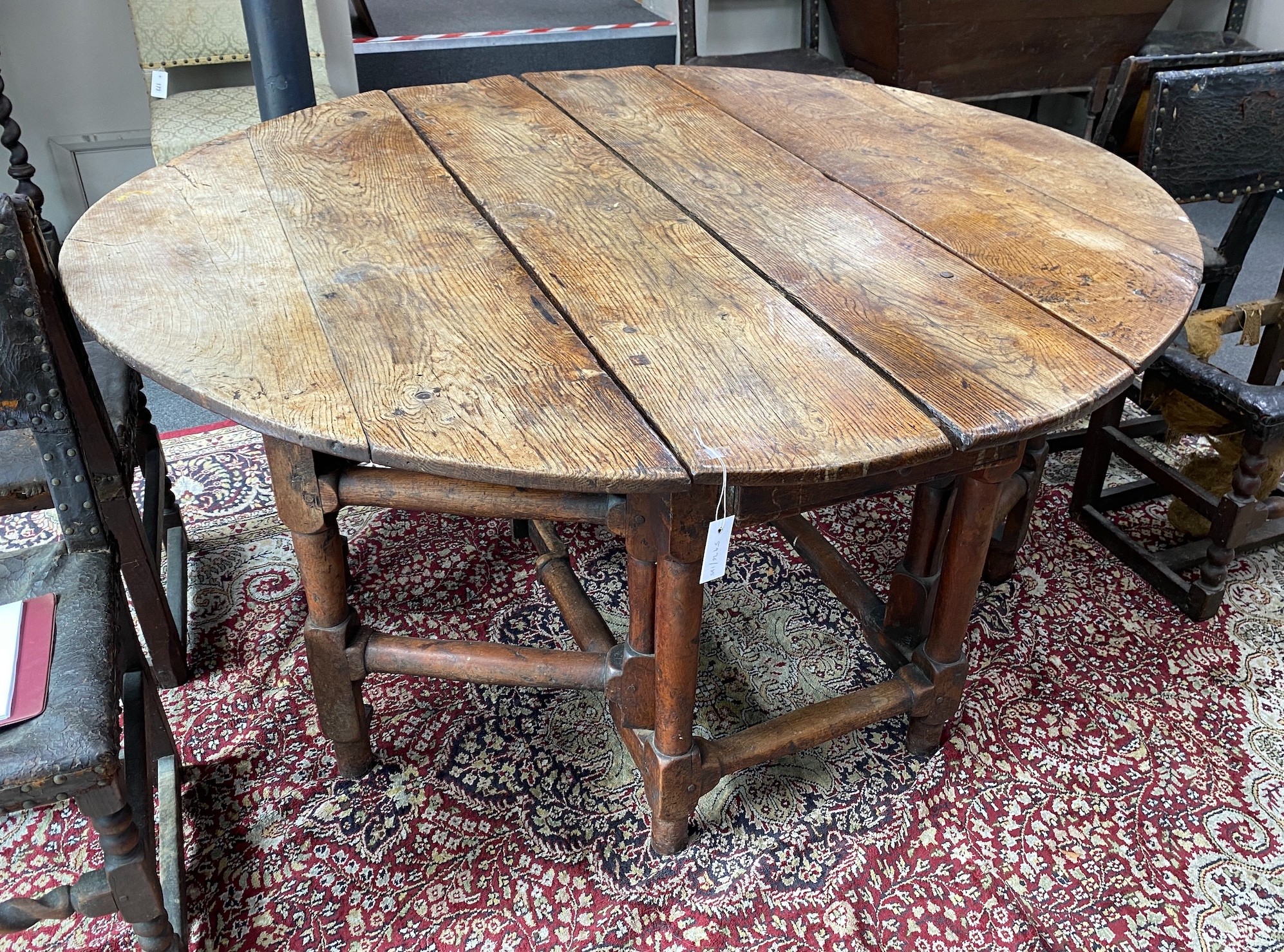 A 17th century oak gateleg table, length 168cm extended, width 150cm, height 76cm